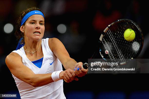 Julia Goerges of Germany plays a backhand in her match against Anastasia Pavlyuchenkova of Russia during day two of the WTA Porsche Tennis Grand Prix...