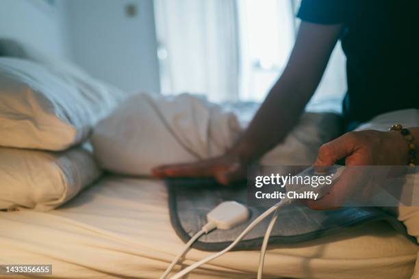 using electric blanket in winter during energy crisis - energy tariff stock pictures, royalty-free photos & images