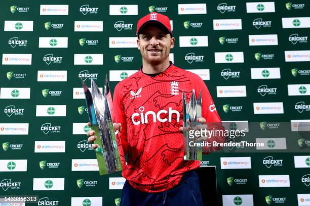 Jos Buttler of England poses with the series trophy and player of the series trophy following the game three of the T20 International series between...