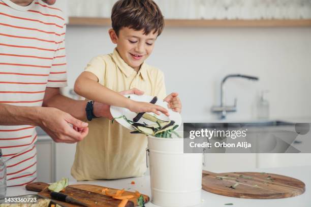 mother and son making compost from vegetable leftovers - compost stock pictures, royalty-free photos & images