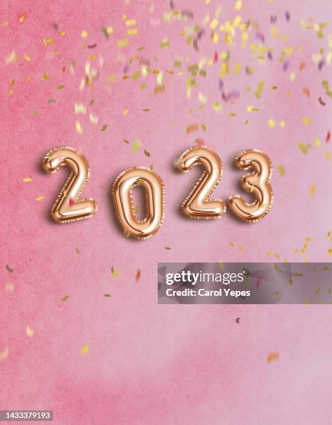 2023 3d letters in pink surface with falling confetti - metallic balloons stock pictures, royalty-free photos & images