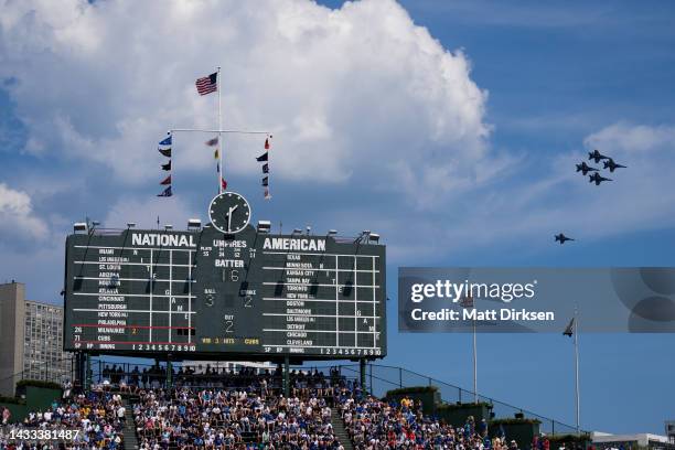 The Blue Angels fly past the Wrigley Field scoreboard during the Chicago Air and Water Show on August 19, 2022 in Chicago, Illinois.