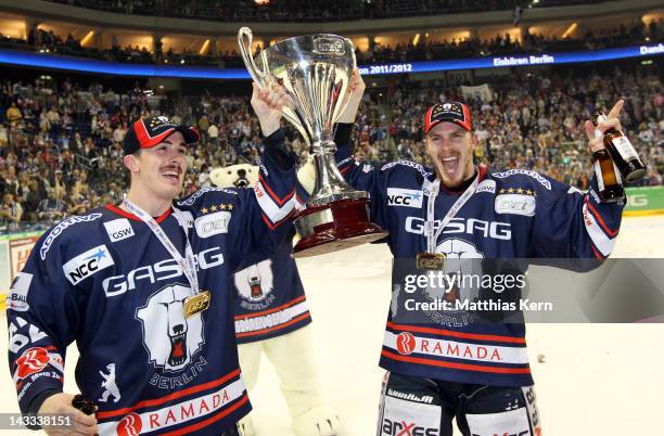 Tyson Mulock of Berlin and team mate T.J. Mulock celebrate with the cup after winning the DEL final match between EHC Eisbaeren Berlin and Adler...