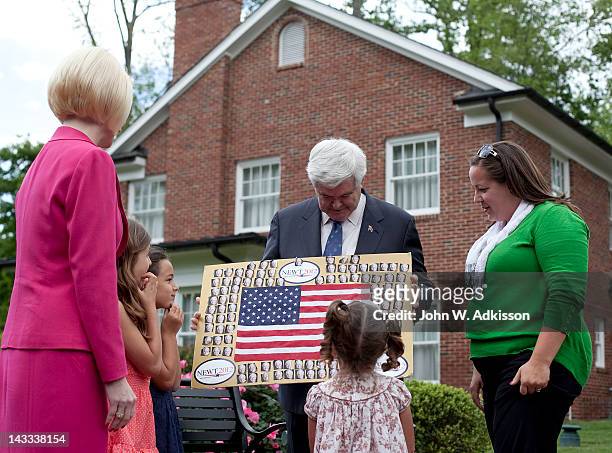 Republican presidential candidate, former Speaker of the House Newt Gingrich speaks with Jessica Salas, right, and her children Gabriela Salas...