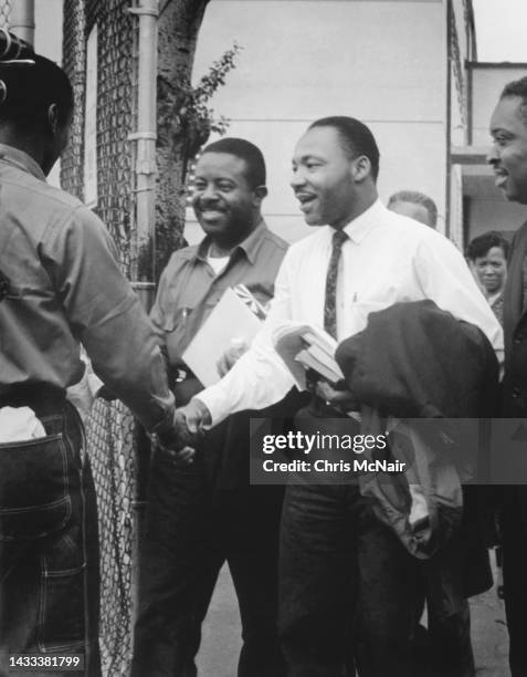 American religious and Civil Rights leaders Reverends Ralph Abernathy and Dr Martin Luther King Jr smile and greet supports as they as released from...