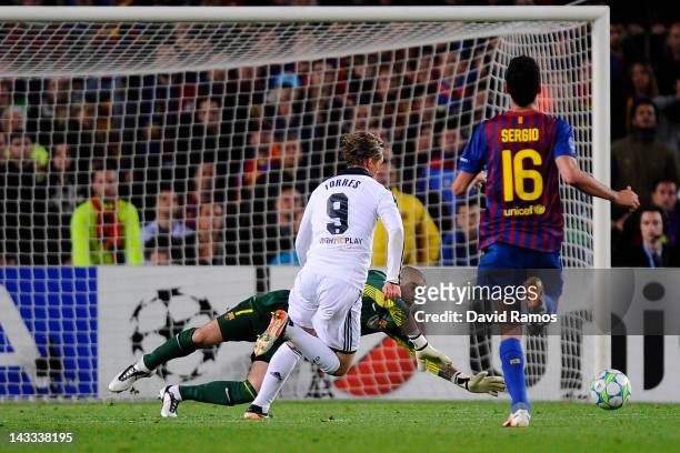 Fernando Torres of Chelsea CF scores his team's second goal under a challenge by goalkeeper Victor Valdes of FC Barcelona during the UEFA Champions...