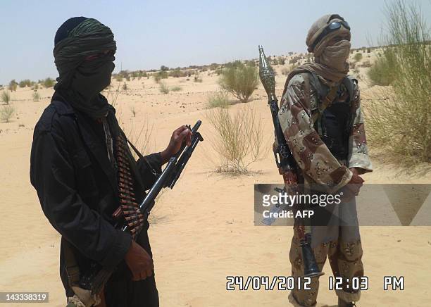 Islamists rebels of Ansar Dine are pictured on April 24, 2012 near Timbuktu, rebel-held northern Mali, during the release of a Swiss hostage. Special...
