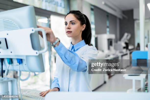 young woman in a laboratory - computer forensic analyst stock pictures, royalty-free photos & images