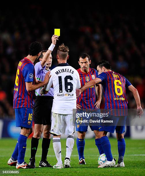 Raul Meireles of Chelsea FC is shown a yellow card by referee Cuneyt Cakir during the UEFA Champions League Semi Final, second leg match between FC...