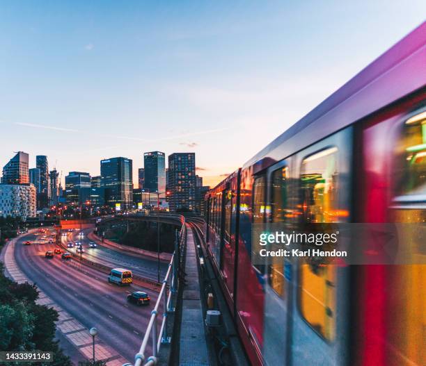 an elevated view of the canary wharf skyline, london - dusk - train vehicle stock-fotos und bilder