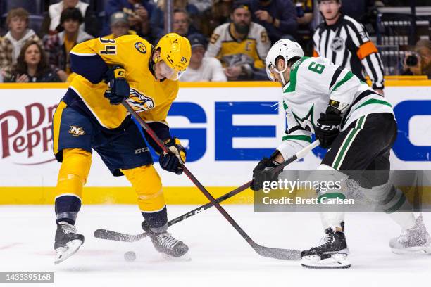 Tanner Jeannot of the Nashville Predators and Colin Miller of the Dallas Stars battle for the puck during the third period at Bridgestone Arena on...