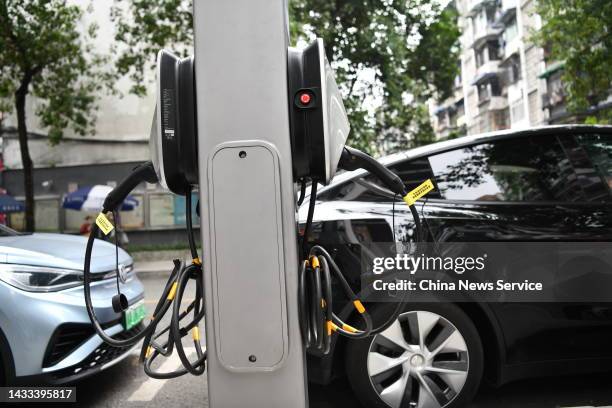 Tesla Model Y electric car is parked at a charging point converted from a lamp post on October 14, 2022 in Chengdu, Sichuan Province of China.