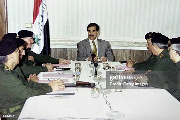 Iraqi President Saddam Hussein chairs a meeting of top government officials September 26, 2002 in Bagdad, Iraq. Yesterday, U.S. President George W....