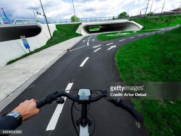 riding electric bicycle in cool urban design with concrete in the western europe. - cykelbana bildbanksfoton och bilder
