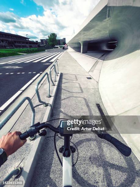 riding electric bicycle from pov in cool urban design in the western europe. - hasselt belgium stock pictures, royalty-free photos & images