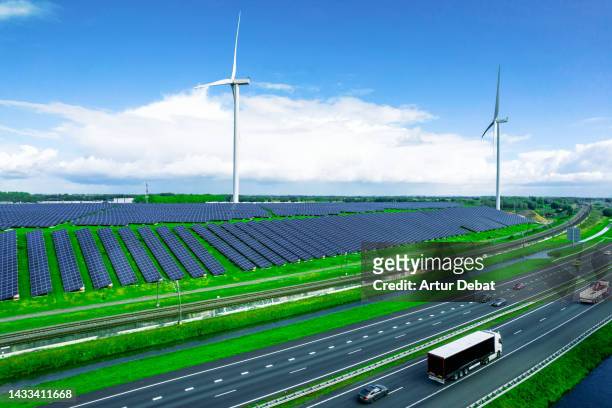 aerial view of idyllic highway with sustainable energies in the netherlands. - air freight transportation stock pictures, royalty-free photos & images