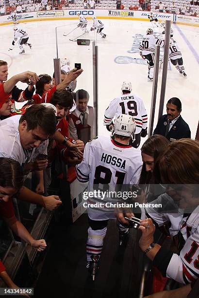 Jonathan Toews and Marian Hossa of the Chicago Blackhawks skates out onto the ice before Game One of the Western Conference Quarterfinals against the...