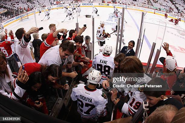 Patrick Kane and Johnny Oduya of the Chicago Blackhawks skate out onto the ice before Game One of the Western Conference Quarterfinals against the...