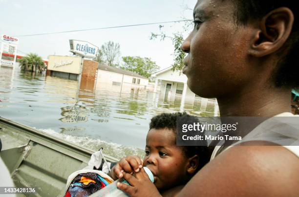 Mother and her child are rescued by boat from the Lower Ninth Ward during the aftermath of Hurricane Katrina August 30, 2005 in New Orleans,...