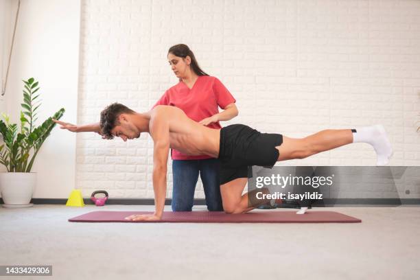 female physiotherapist is examining to her patient. - posture stock pictures, royalty-free photos & images