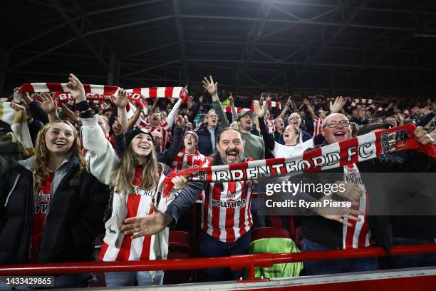 Brentford FC fans hold up scarves to show their support prior to the Premier League match between Brentford FC and Brighton & Hove Albion at...