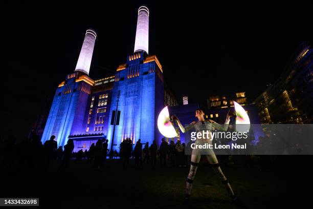 Dancer performs with light panels during the "Festival of Power" to mark the opening of Battersea Power station on October 14, 2022 in London,...