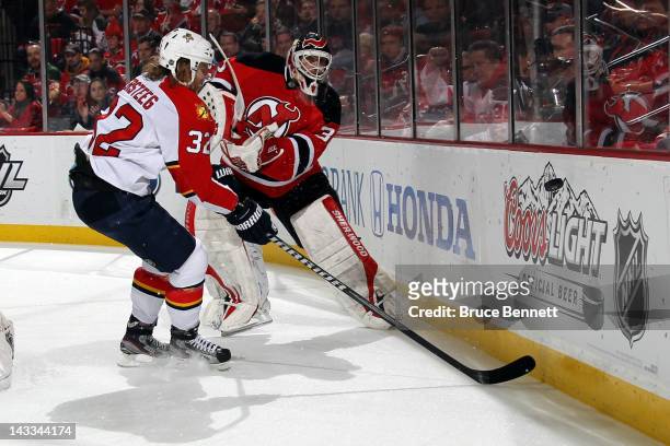 Goalie Martin Brodeur of the New Jersey Devils clears the puck in the first period against Kris Versteeg of the Florida Panthers in Game Six of the...