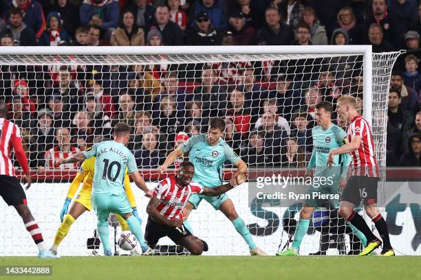 Ivan Toney of Brentford is tackled by Joel Veltman of Brighton & Hove Albion leading to a penalty decision during the Premier League match between...