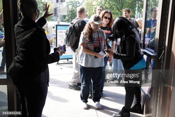 Visitors show their tickets as they enter The Smithsonian National Air and Space Museum for the museum’s reopening on October 14, 2022 in Washington,...