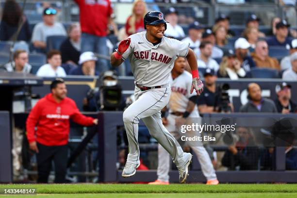 Oscar Gonzalez of the Cleveland Guardians rounds third base on his way to scoring a run on a one-run RBI double hit by Josh Naylor during the tenth...