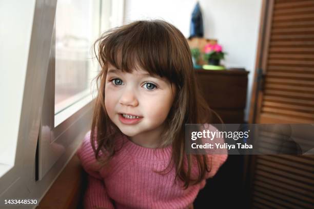 feliz hermosa niña de 3 años con grandes ojos verdes jugando en casa. niño sonriente - giving a girl head fotografías e imágenes de stock