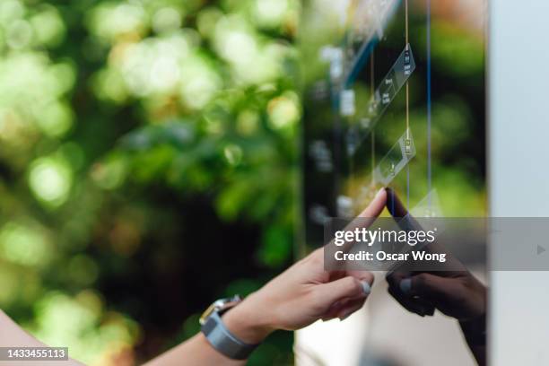 female hand touching digital display screen - gesture control screen stockfoto's en -beelden