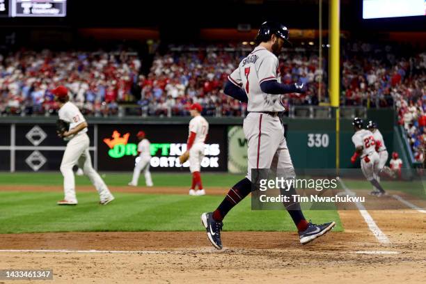 Dansby Swanson of the Atlanta Braves scores a run off of an RBI single hit by Michael Harris II against Aaron Nola of the Philadelphia Phillies...