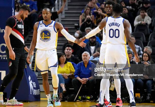 Moses Moody of the Golden State Warriors is congratulated by Jonathan Kuminga after Moody scored and was fouled on the shot against the Portland...