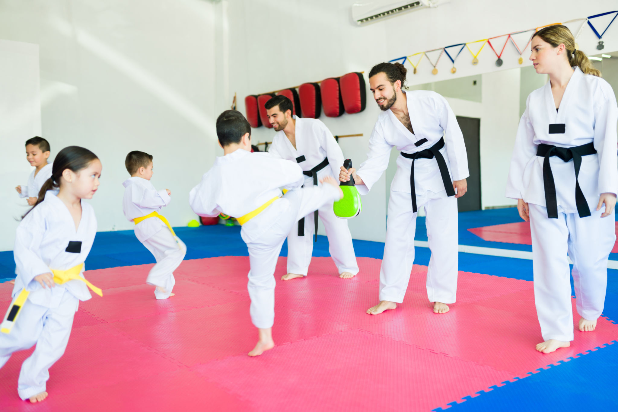 Karate trainers practicing taekwondo with children Karate trainers practicing taekwondo with children
