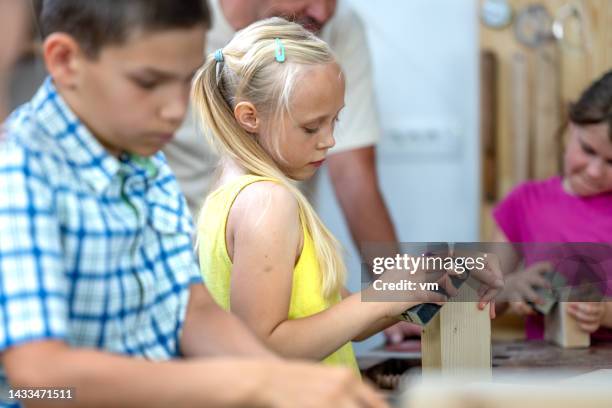 kids doing woodwork at handcraft class, medium shot - craft product stock pictures, royalty-free photos & images