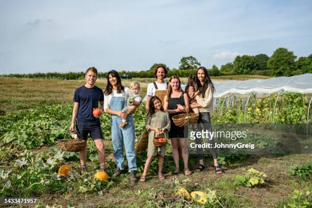 portrait of farmers and families in pumpkin patch - autarkie stockfoto's en -beelden