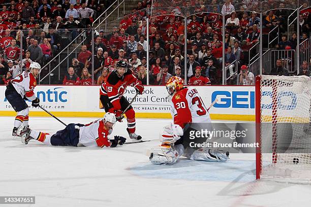 Travis Zajac of the New Jersey Devils scores the game-winning goal in overtime against goalie Scott Clemmensen of the Florida Panthers in Game Six of...