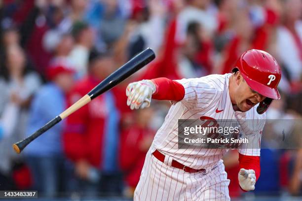 Rhys Hoskins of the Philadelphia Phillies celebrates by spiking his bat after hitting a three-run home run against Spencer Strider of the Atlanta...