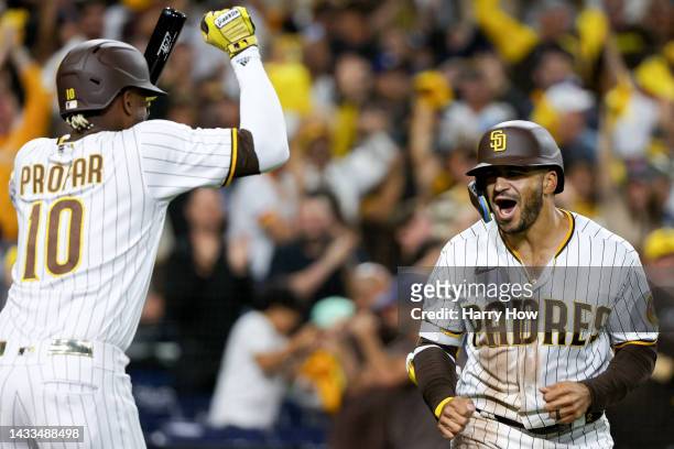 Trent Grisham of the San Diego Padres celebrates his home run against the Los Angeles Dodgers with teammate Jurickson Profar during the fourth inning...