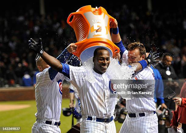 Alfonso Soriano of the Chicago Cubs receives a Gatorade bath from teammates Reed Johnson and Jeff Baker after hitting a game-winning RBI single...