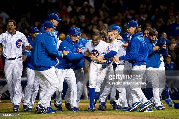 Alfonso Soriano of the Chicago Cubs is mobbed by his teammates after hitting a game-winning RBI single scoring Tony Campana during the 10th inning...