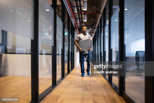 casual business man moving office - carrying desktop stock pictures, royalty-free photos & images