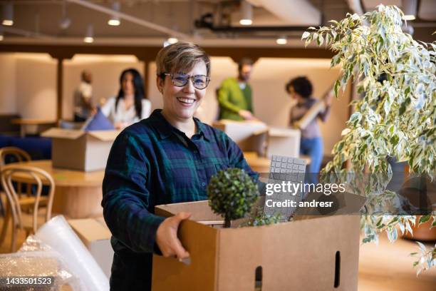 happy business woman moving into a new office - mudança de escritório imagens e fotografias de stock