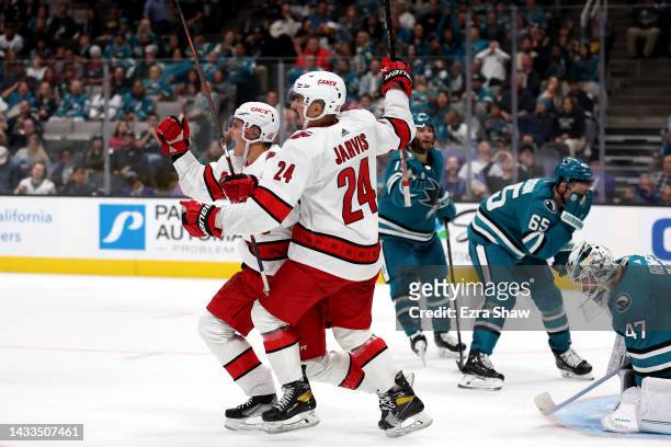Sebastian Aho of the Carolina Hurricanes celebrates with Seth Jarvis after he scored the winning goal against the San Jose Sharks in the third period...