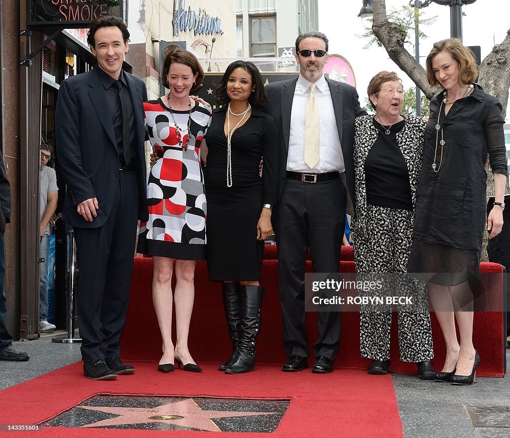 Actor John Cusack poses with family and friends after receiving his