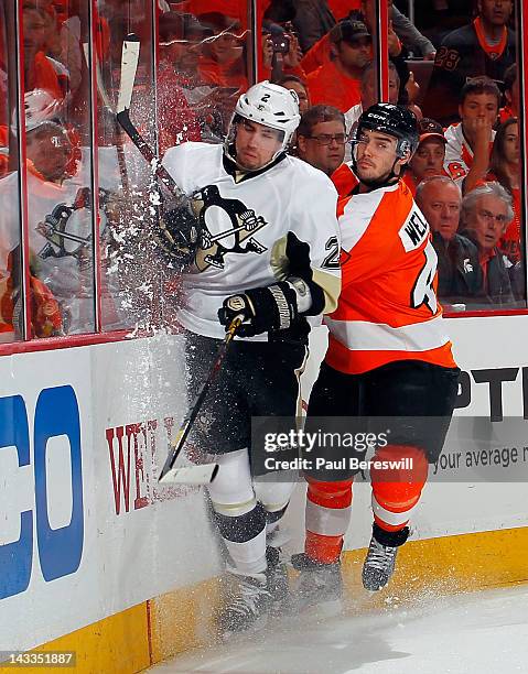 Matt Niskanen of the Pittsburgh Penguins is checked by Eric Wellwood of the Philadelphia Flyers in Game Six of the Eastern Conference Quarterfinals...