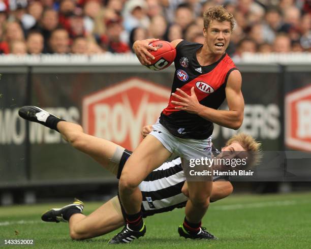 Jake Melksham of the Bombers is tackled by Ben Sinclair of the Magpies during the round five AFL match between the Collingwood Magpies and the...