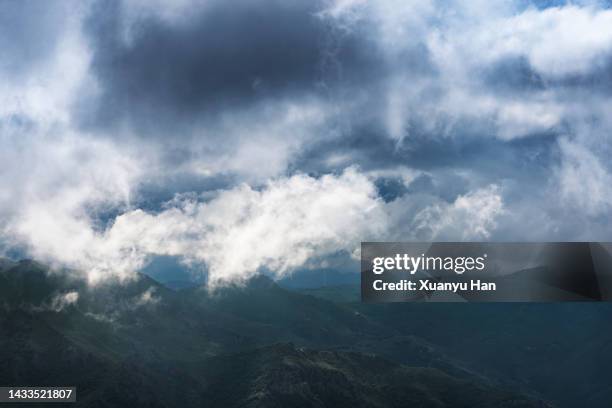 clouds covered with mountains - ominous mountains stock pictures, royalty-free photos & images