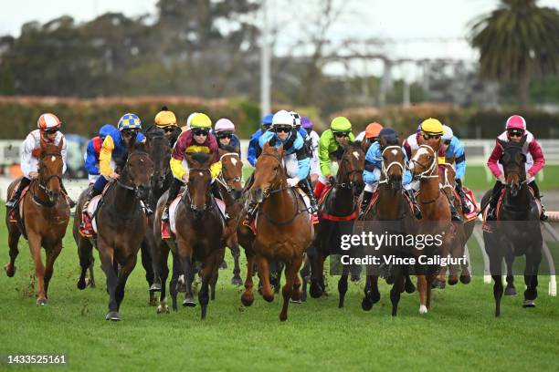 Horse turn into the first turn in Race 9, the Carlton Draught Caulfield Cup, during Caulfield Cup Day at Caulfield Racecourse on October 15, 2022 in...
